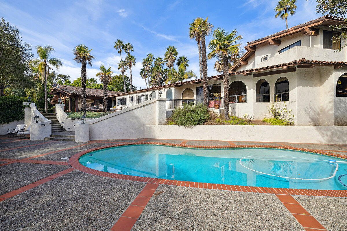 Garden path flanked by Mediterranean landscaping.