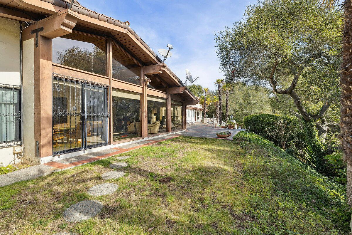 Glass-walled living room opens to the garden.